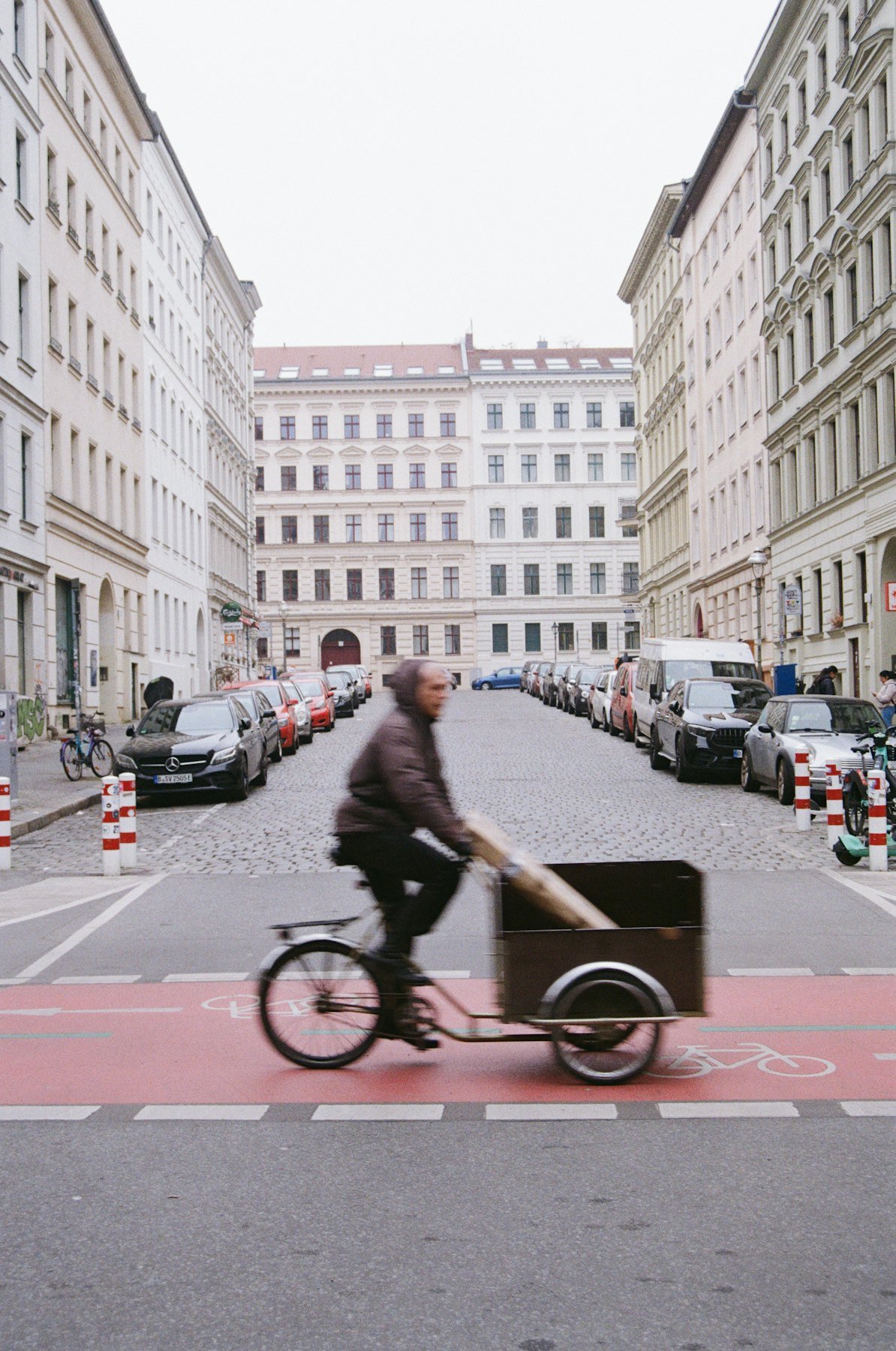 Cargo bike courier riding through a Berlin street