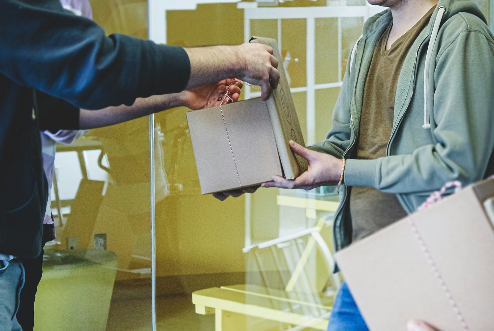 Courier handing a sealed document envelope to a recipient