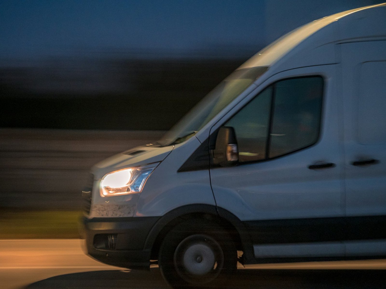 Courier van travelling on the road