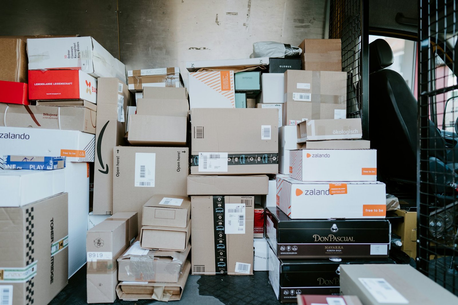 Parcels stacked in the back of a courier van ready for European express delivery