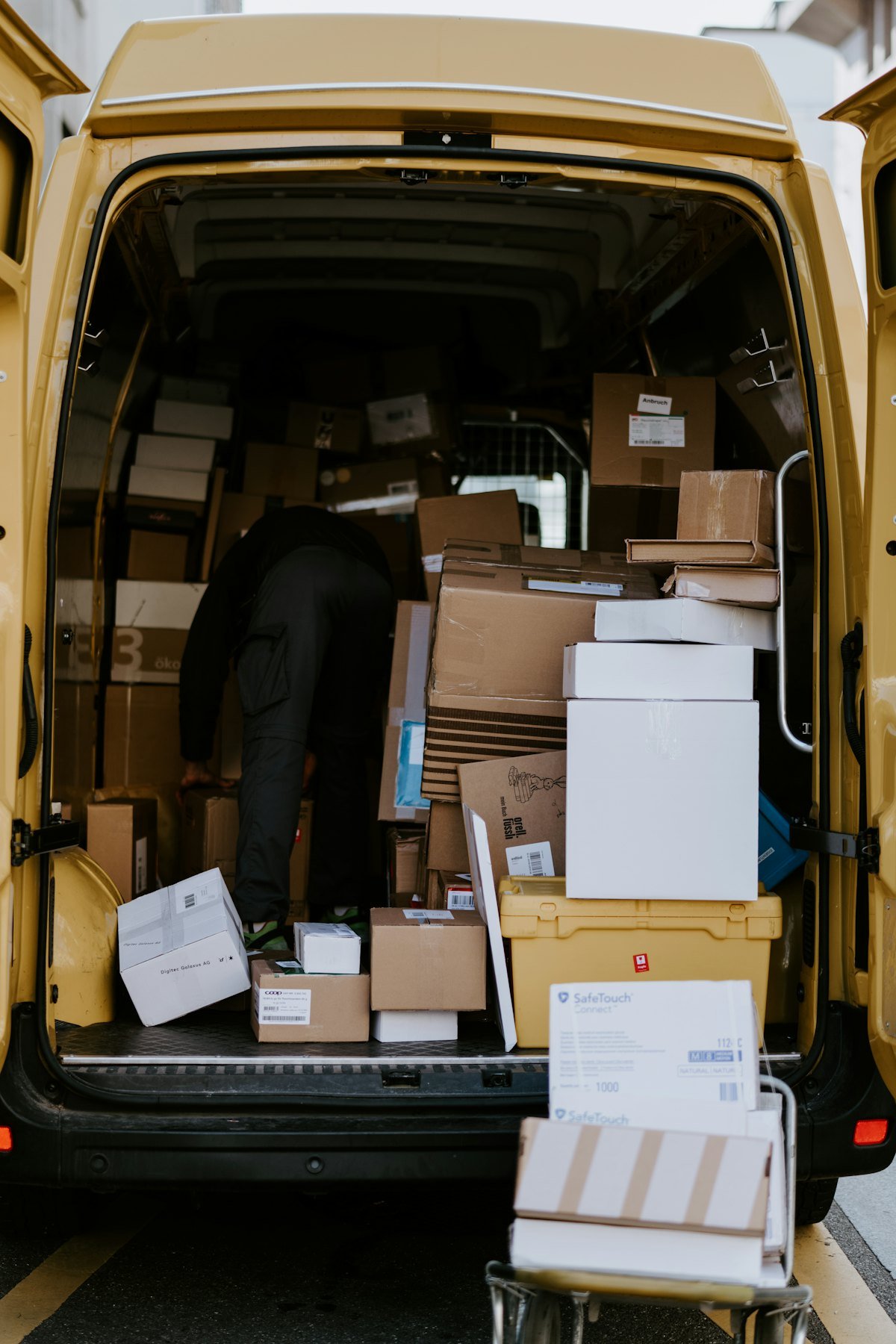 Courier loading parcels into the back of a delivery van in Berlin