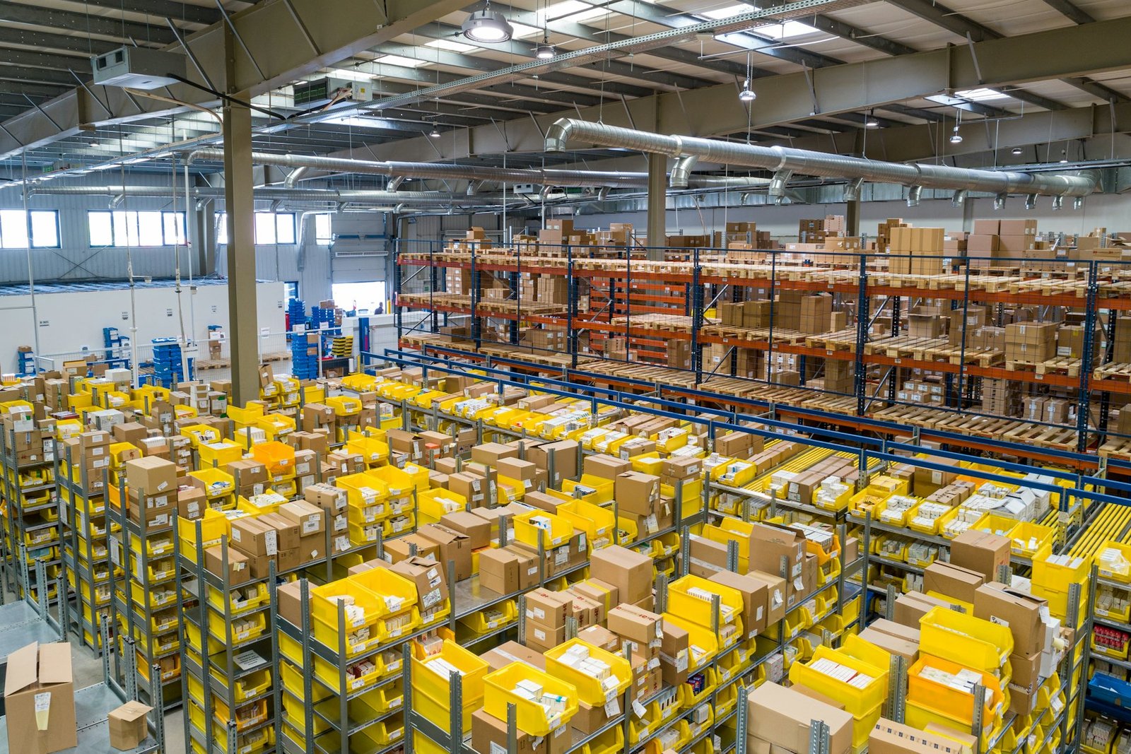 Warehouse with pallets of yellow crates ready for transport
